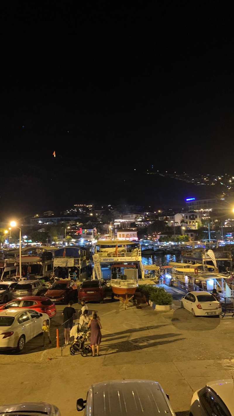 night view of Kas town in Antalya, lights are shiny and there are little boats on the sea