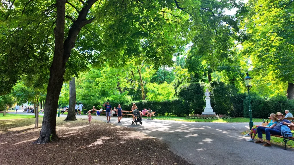 people are resting in the stadtpark ( city park) Vienna